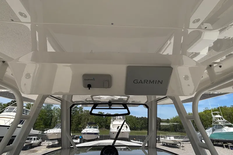 Slide: The Image of 2023 Regulator 41 boat with Garmin electronics, docked among other boats. - 38