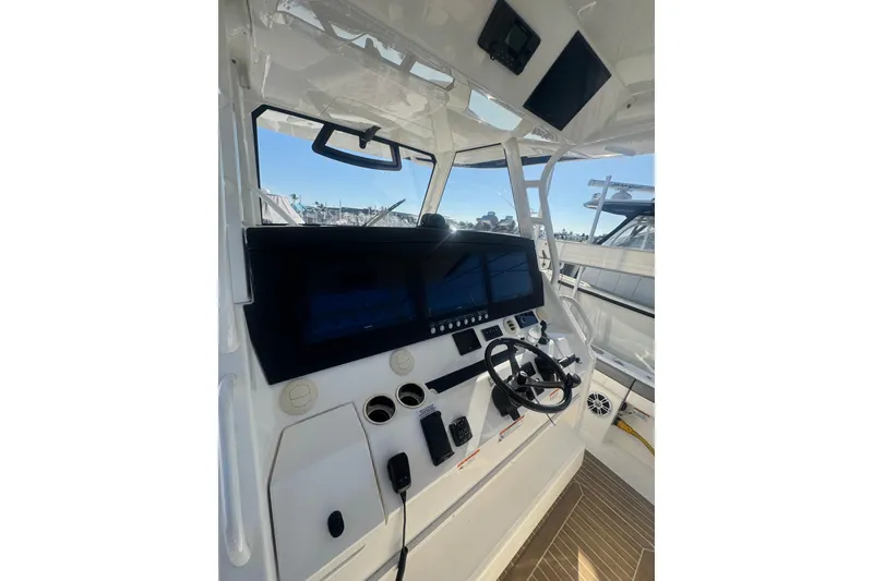 Slide: The Image of 2023 Regulator 41 boat helm with modern controls and navigation screens. - 39