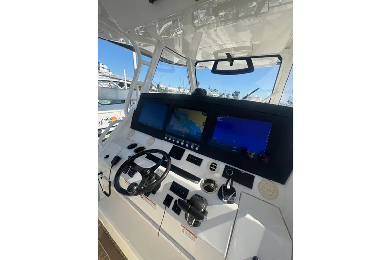 Slide: The Image of 2023 Regulator 41 boat dashboard with advanced navigation screens and controls. - 40