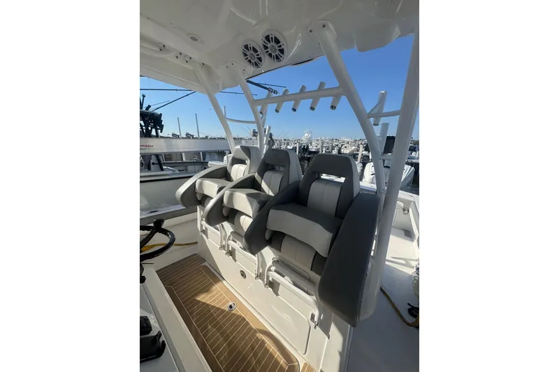Slide: The Image of 2023 Regulator 41 boat interior with cushioned seating and rod holders. - 42