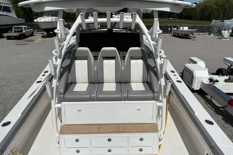 Slide: The Image of 2023 Regulator 41 boat interior with seating and rod holders, docked outdoors. - 43