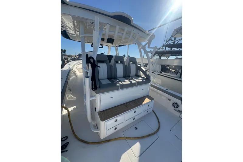 Slide: The Image of 2023 Regulator 41 boat interior with cushioned seating and storage drawers. - 47