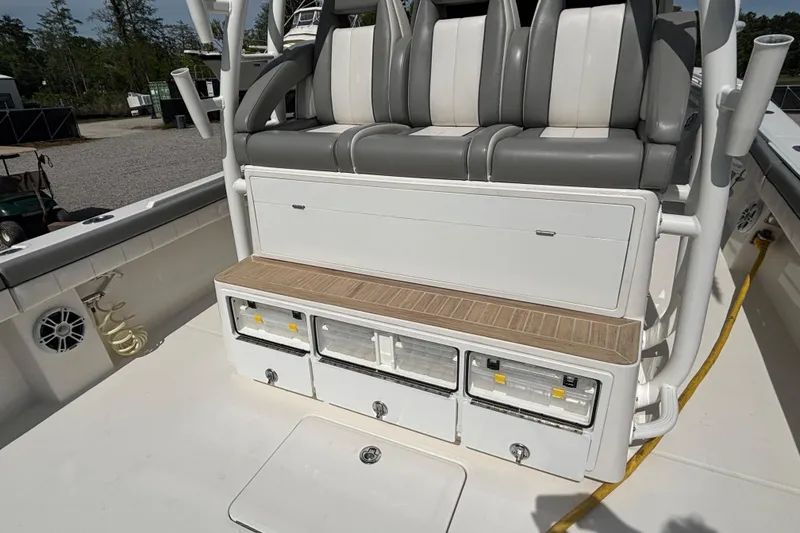 Slide: The Image of 2023 Regulator 41 boat seating area with storage compartments and rod holders. - 48
