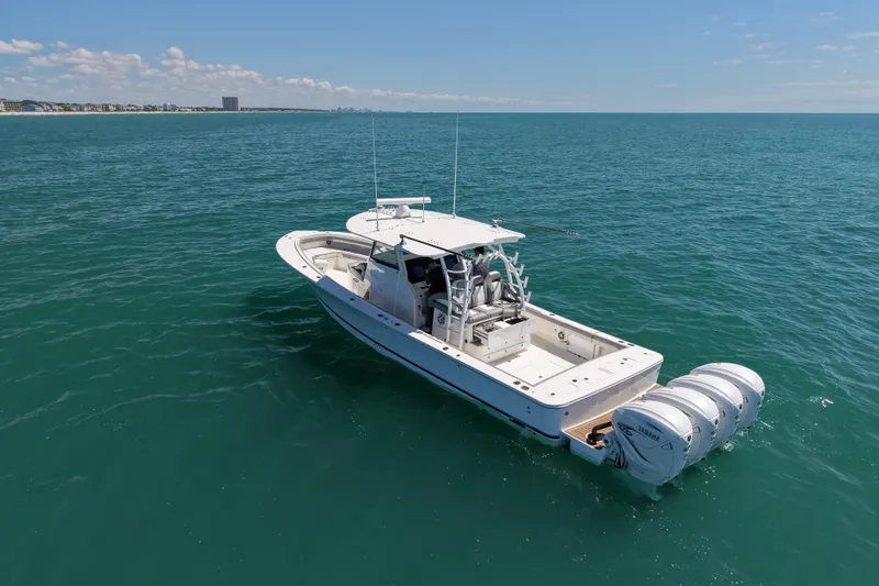 Slide: The Image of 2023 Regulator 41 boat on open ocean, featuring triple outboard engines. - 5