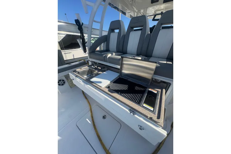 Slide: The Image of 2023 Regulator 41 boat interior with grill and seating area. - 50