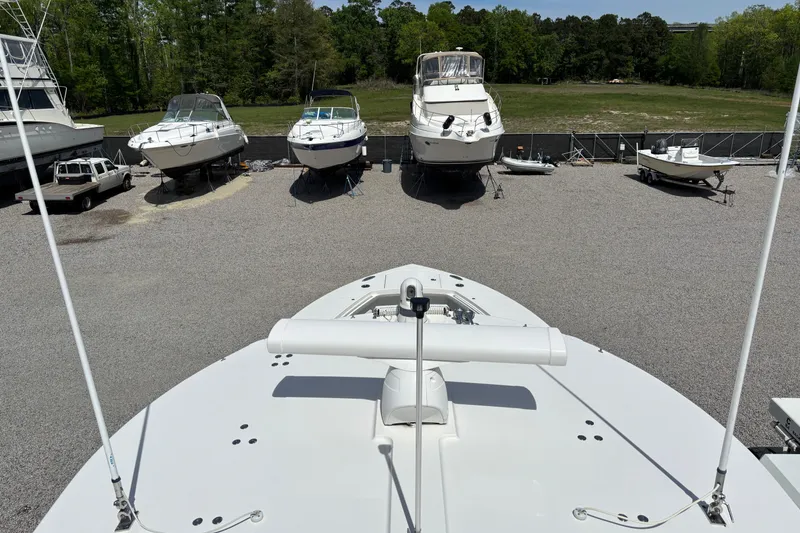 Slide: The Image of 2023 Regulator 41 boat in a marina with other vessels and greenery. - 51