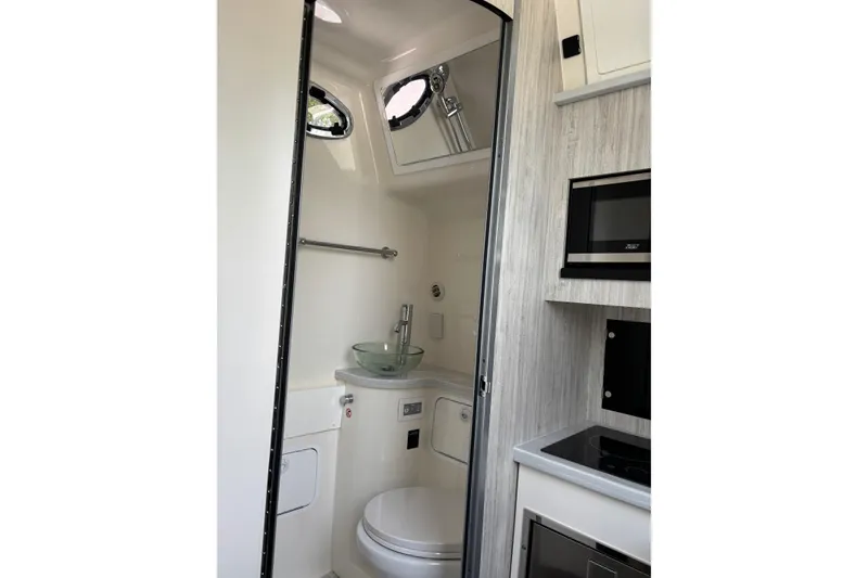Slide: The Image of 2023 Regulator 41 boat interior with modern bathroom and kitchenette amenities. - 58