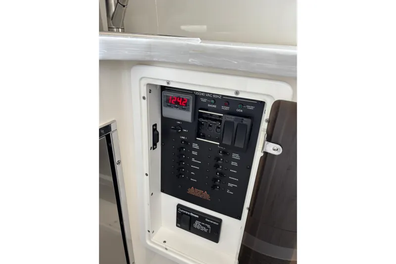 Slide: The Image of Electrical control panel on 2023 Regulator 41 boat, featuring digital display and switches. - 60