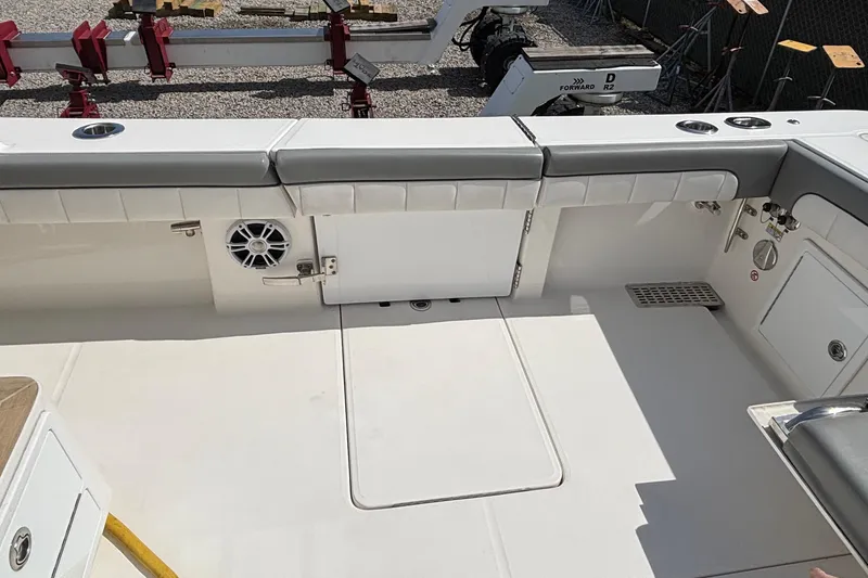 Slide: The Image of 2023 Regulator 41 boat deck with cushioned seating and built-in speaker. - 62