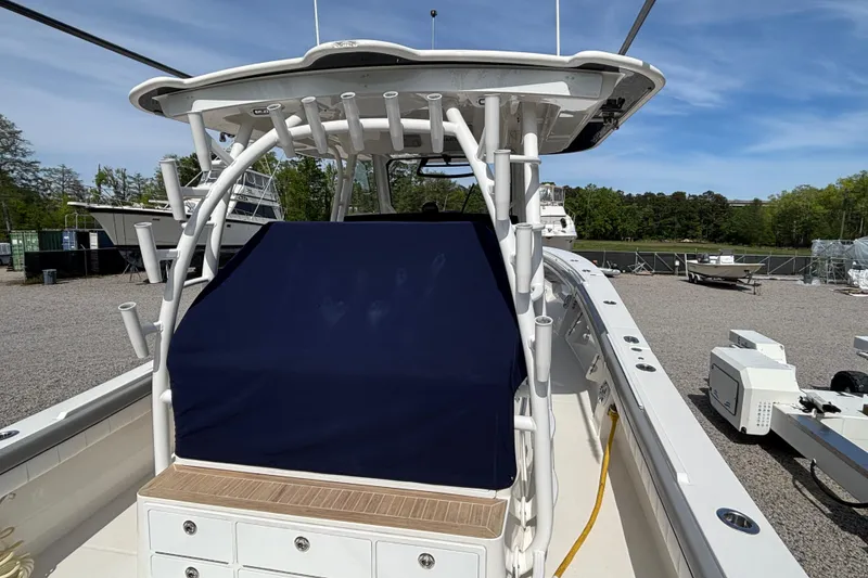 Slide: The Image of 2023 Regulator 41 boat with covered console, docked outdoors under clear sky. - 64
