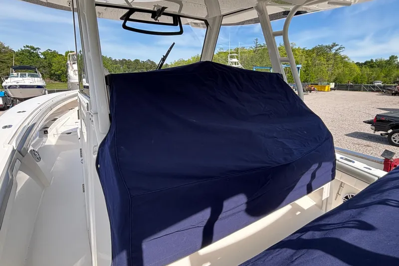 Slide: The Image of 2023 Regulator 41 boat with covered console, docked outdoors on a sunny day. - 67