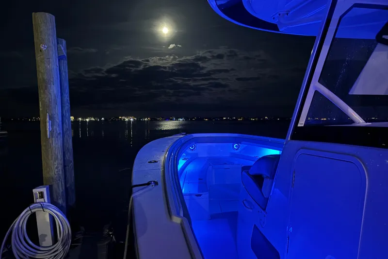 Slide: The Image of 2023 Regulator 41 boat illuminated at night under a full moon. - 7
