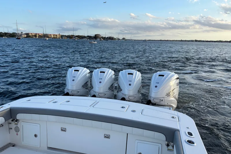 Slide: The Image of 2023 Regulator 41 boat with four Yamaha V8 engines on open water. - 74