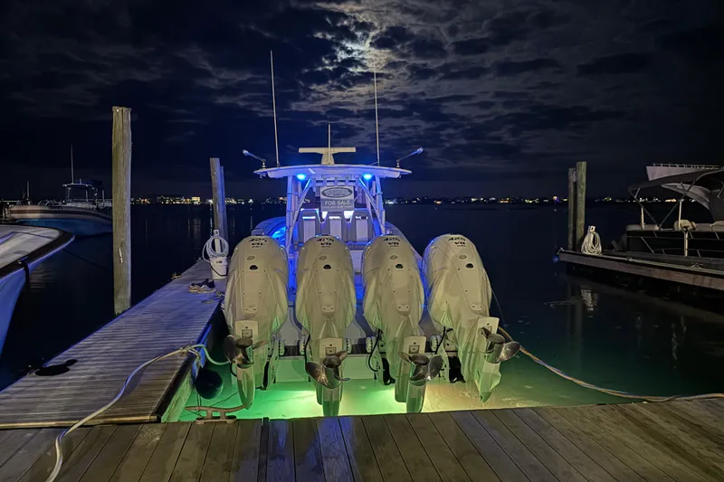 Slide: The Image of 2023 Regulator 41 boat docked at night with illuminated engines. - 76