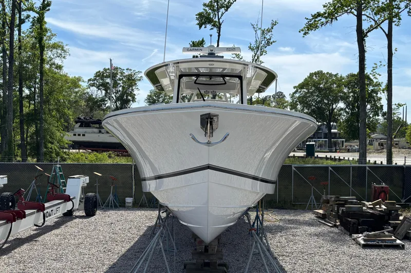 Slide: The Image of 2023 Regulator 41 boat on dry dock, surrounded by trees and equipment. - 8