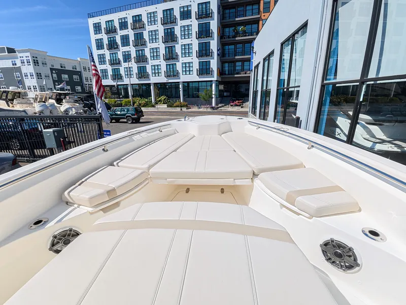 Slide: The Image of The image shows the deck of a 2027 Boston Whaler 280 Dauntless with beige cushions. - 21