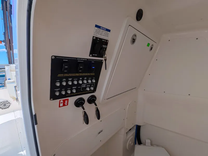 Slide: The Image of Interior view of a boat with a control panel and keys, light-colored walls, and a window. - 17