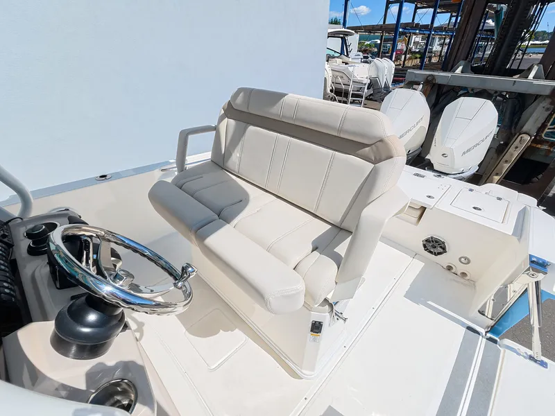 Slide: The Image of The 2027 Boston Whaler 280 Dauntless features a sleek cockpit with beige upholstered seating and steering. - 15