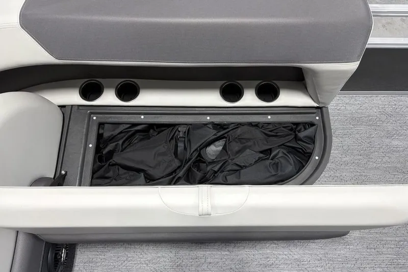 Slide: The Image of 2026 Sun Tracker Bass Buggy 16 XL Select storage compartment with cup holders and black cover. - 13