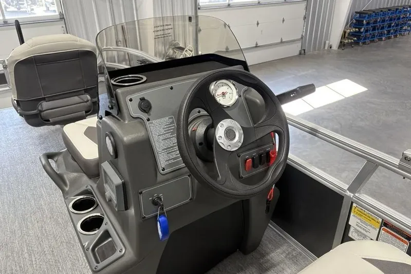 Slide: The Image of 2026 Sun Tracker Bass Buggy 16 XL Select boat console with steering wheel and controls. - 18