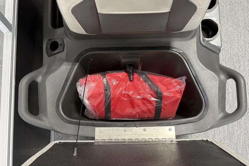 Slide: The Image of Storage compartment in 2026 Sun Tracker Bass Buggy 16 XL Select with red life jacket. - 7