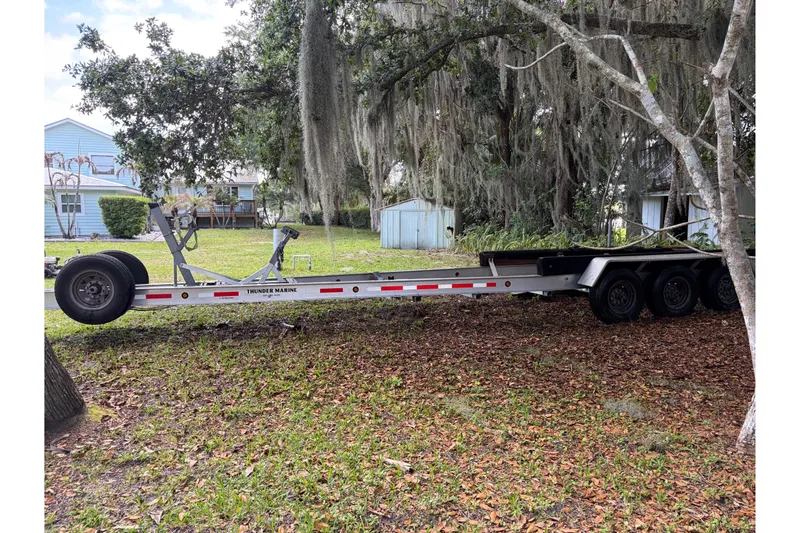 Slide: The Image of 1995 Grady-White Marlin 300 boat deck with seating and cooler, docked by the water. - 10