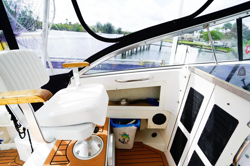 Slide: The Image of Interior of a 1995 Grady-White Marlin 300 boat with white captain's chair. - 13