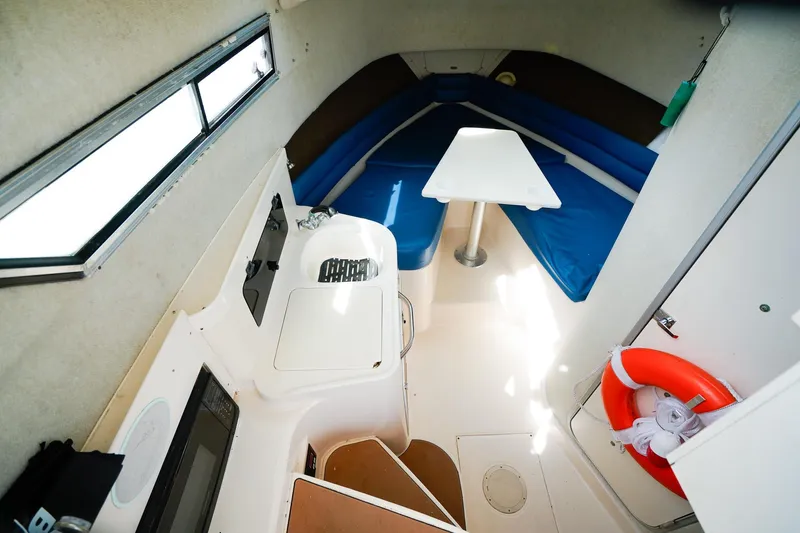 Slide: The Image of Interior of 1995 Grady-White Marlin 300 boat with seating and table. - 14
