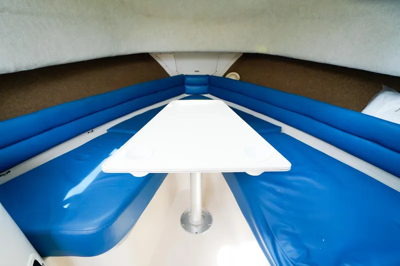 Slide: The Image of 1995 Grady-White Marlin 300 cabin interior with blue seating and white table. - 17