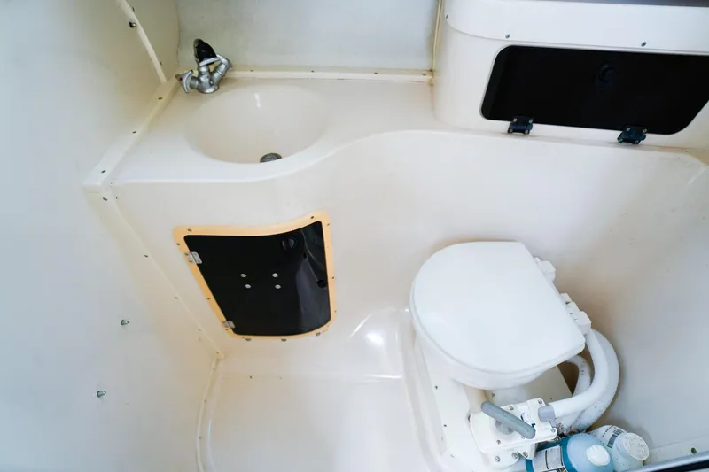 Slide: The Image of 1995 Grady-White Marlin 300 boat bathroom with sink and toilet. - 18