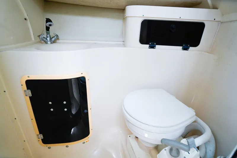 Slide: The Image of 1995 Grady-White Marlin 300 boat bathroom with toilet and sink. - 19