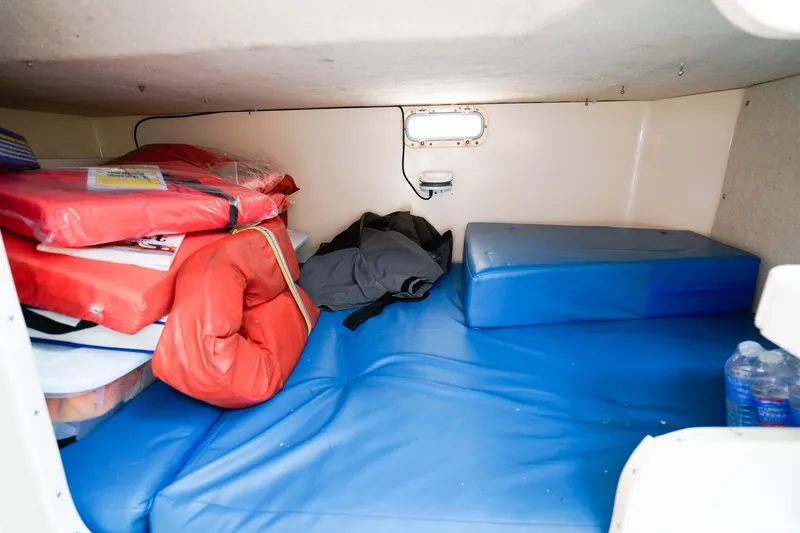 Slide: The Image of Interior cabin of 1995 Grady-White Marlin 300 with life jackets and cushions. - 20