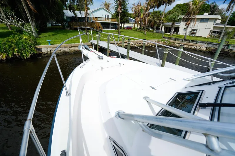 Slide: The Image of 1995 Grady-White Marlin 300 boat docked near waterfront homes. - 23