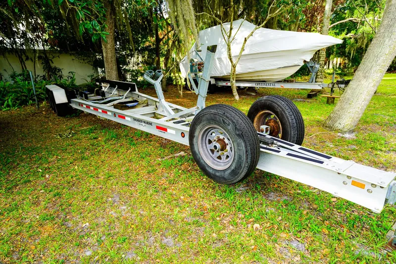 Slide: The Image of Trailer for 1995 Grady-White Marlin 300 boat parked on grass. - 31