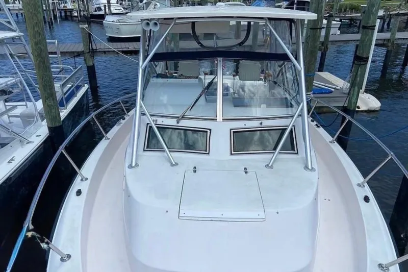 Slide: The Image of 1995 Grady-White Marlin 300 boat interior with teak flooring and fishing equipment. - 5