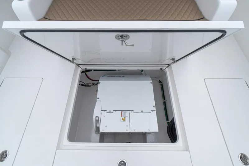 Slide: The Image of 2026 Valhalla Boatworks V-41 storage compartment with open hatch, showcasing interior equipment. - 10
