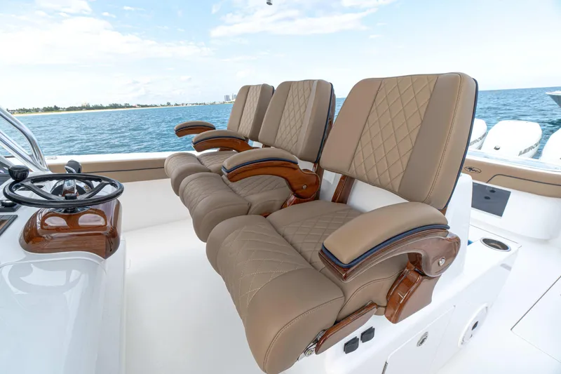 Slide: The Image of Luxurious seating on 2026 Valhalla Boatworks V-41, featuring elegant tan upholstery and ocean backdrop. - 4