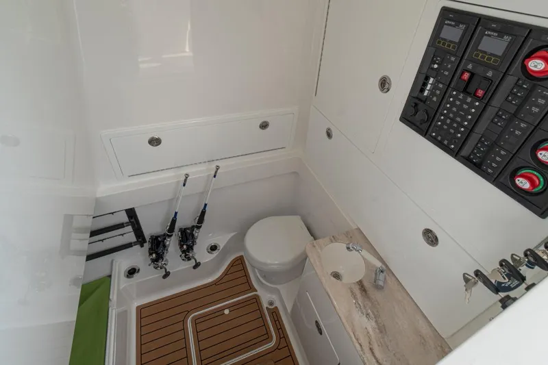 Slide: The Image of 2026 Valhalla Boatworks V-41 interior with fishing rods, control panel, and compact bathroom. - 8