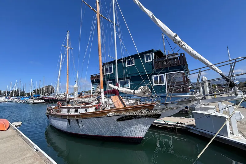 The Image of Classic 1970 Ketch sailboat navigating open sea under clear blue sky. - 0
