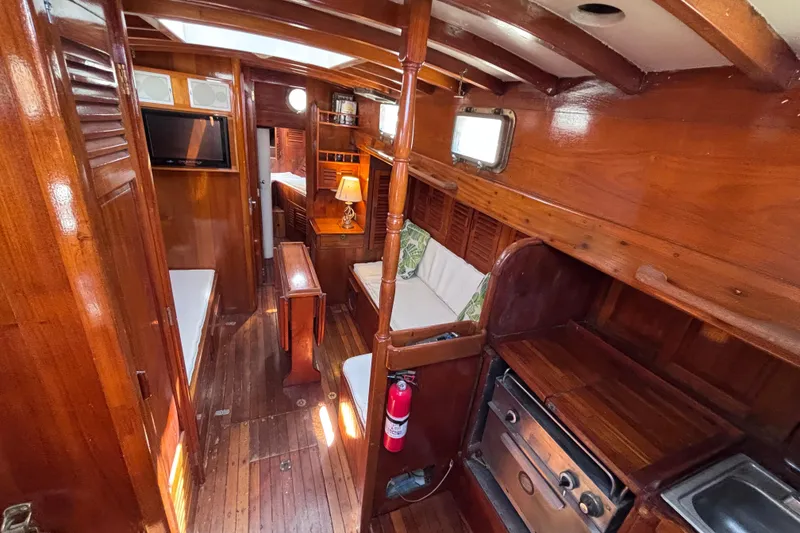 Slide: The Image of Vintage 1970 Chen boat interior with wooden furnishings and cozy seating area. - 10
