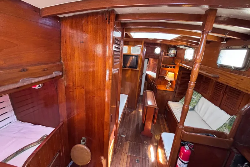 Slide: The Image of Vintage 1970 Chen boat interior with wooden furnishings and cozy seating area. - 11