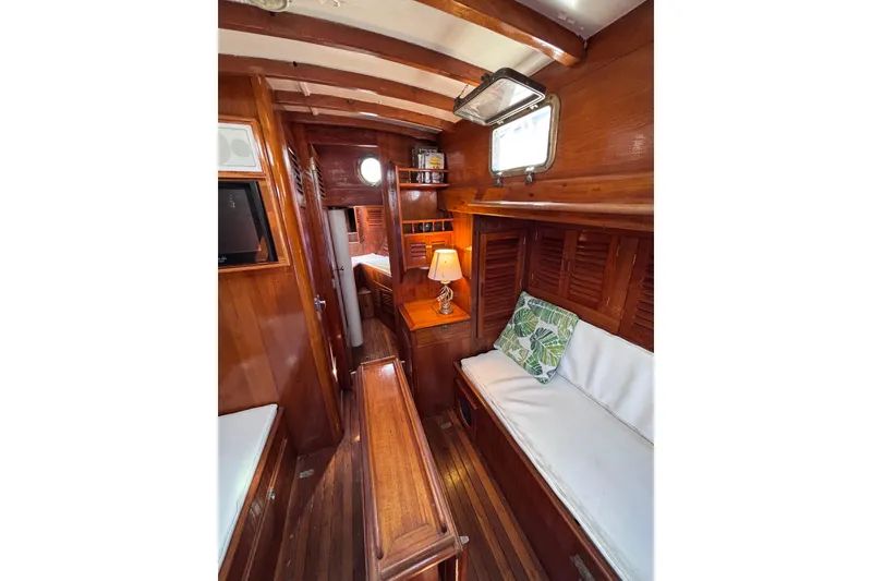 Slide: The Image of Cozy 1970 Chen boat interior with wooden furnishings and cushioned seating. - 12