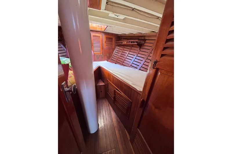 Slide: The Image of Wooden boat cabin interior with bed, featuring vintage 1970 Chen design elements. - 13
