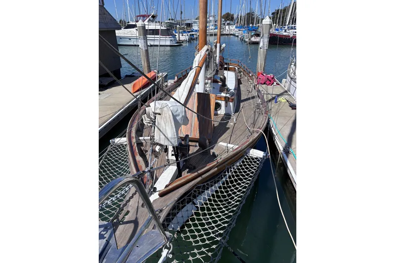 Slide: The Image of Vintage 1970 Chen sailboat docked at marina with wooden deck and rigging. - 2