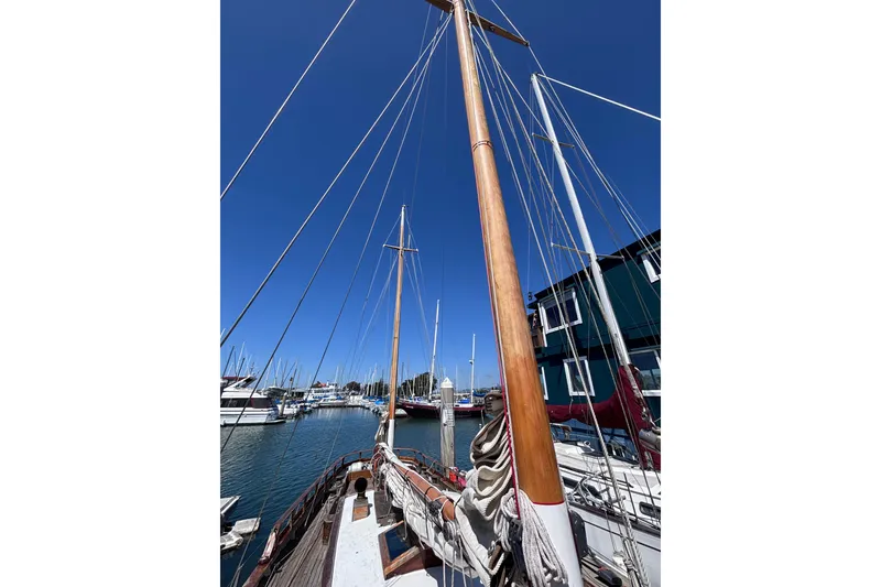 Slide: The Image of Vintage 1970 Chen sailboat docked at marina under clear blue sky. - 6