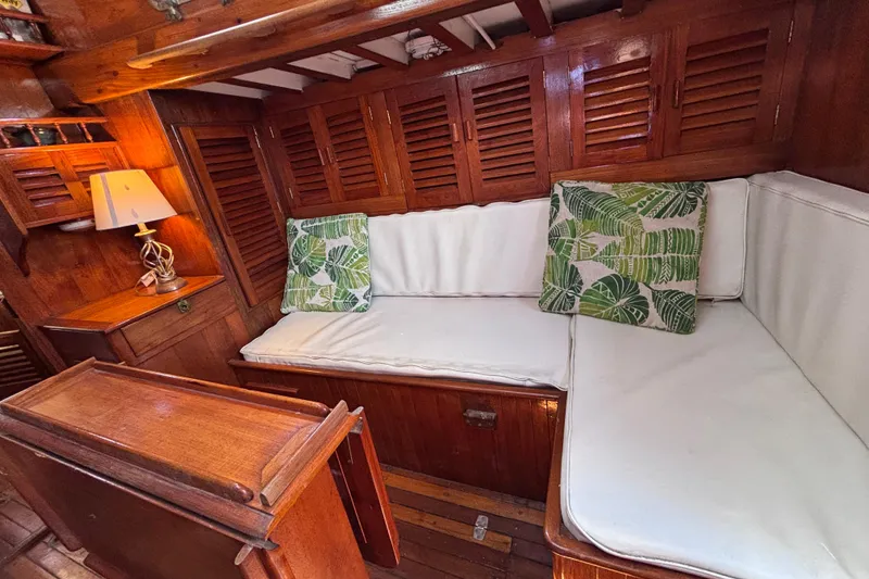 Slide: The Image of Vintage 1970 Chen boat interior with wooden paneling and white cushioned seating. - 7