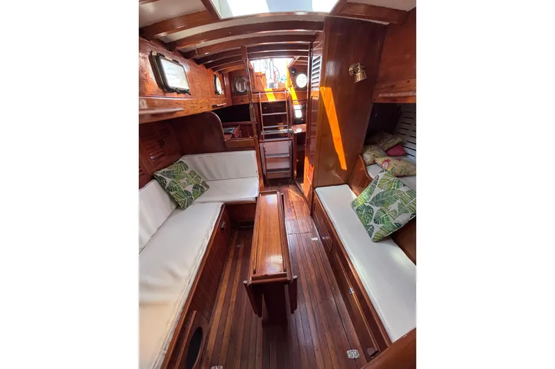 Slide: The Image of Vintage 1970 Chen boat interior with wooden finish and cushioned seating. - 8