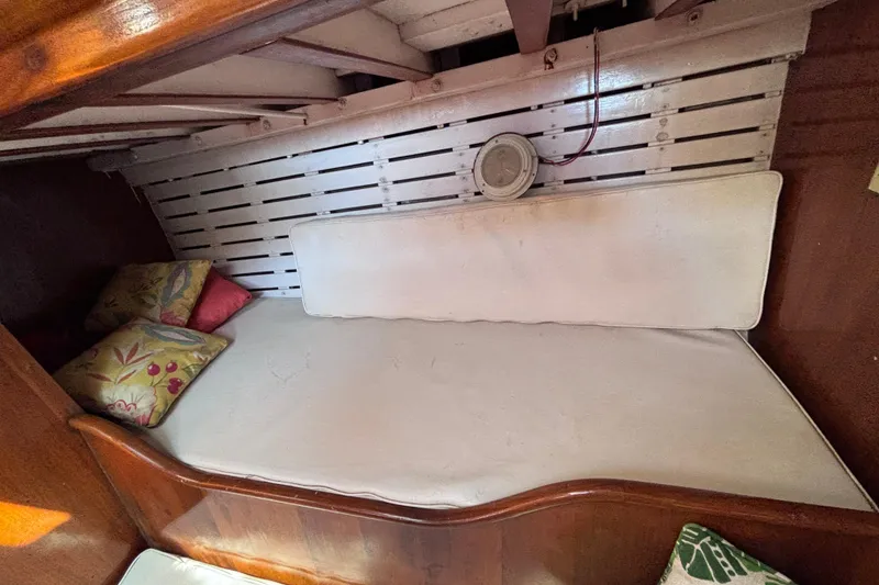 Slide: The Image of Vintage 1970 Chen boat interior with cushioned seating and decorative pillows. - 9