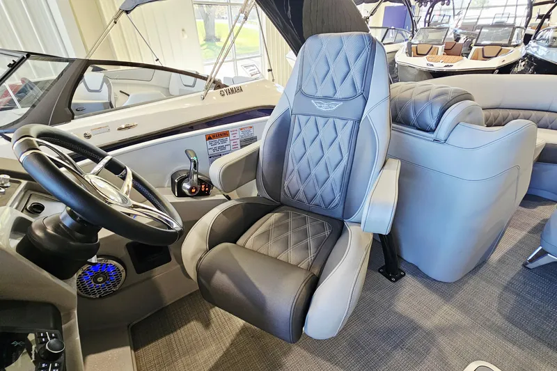Slide: The Image of 2024 Bennington RX 23 RXFBA boat interior with luxury seating and steering wheel. - 13