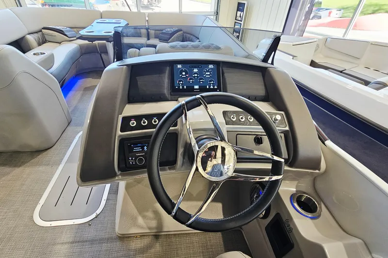 Slide: The Image of 2024 Bennington RX 23 RXFBA boat interior with modern steering console and seating. - 14